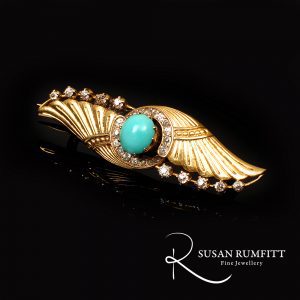 Art Deco Egyptian revival gold brooch with diamonds and turquoise.