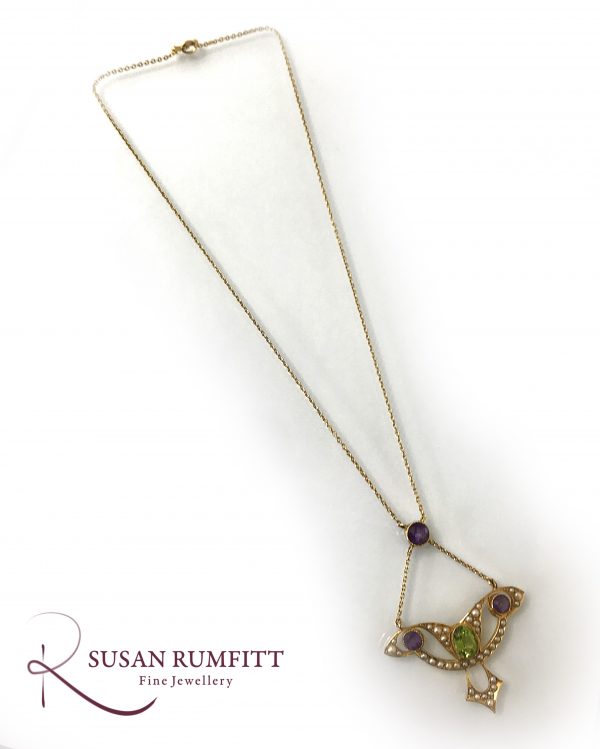 An Art Nouveau Amethyst, Peridot and Seed Pearl Suffragette Pendant