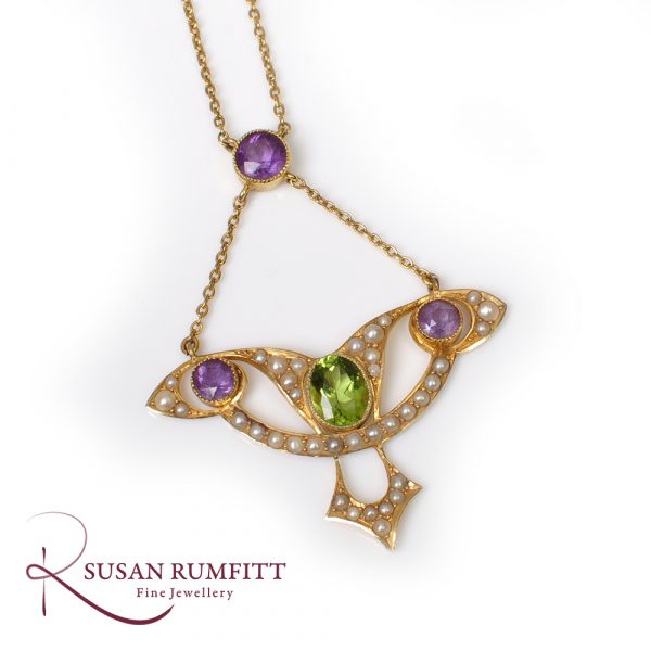 An Art Nouveau Amethyst, Peridot and Seed Pearl Suffragette Pendant