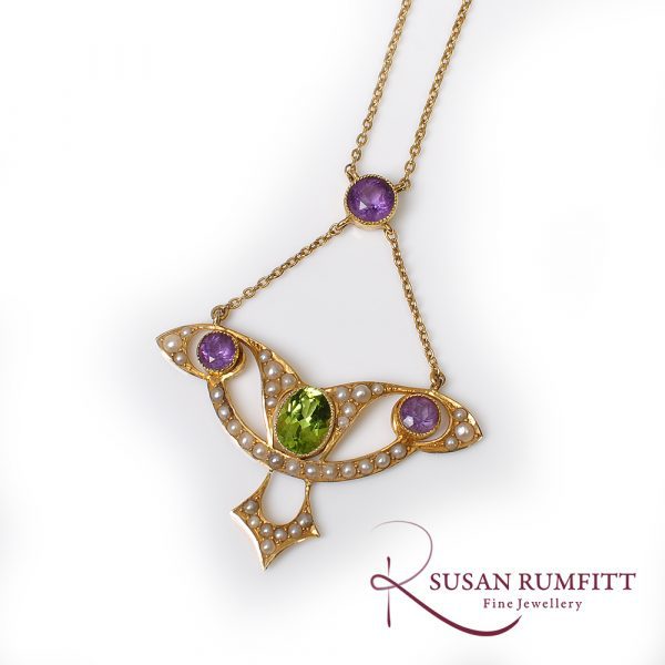 An Art Nouveau Amethyst, Peridot and Seed Pearl Suffragette Pendant