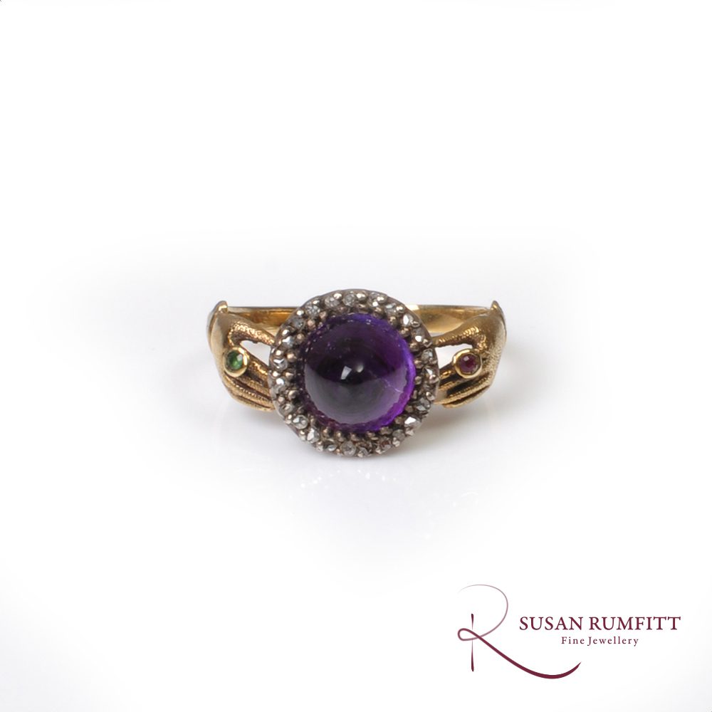 An antique amethyst sugar loaf and diamond fede ring