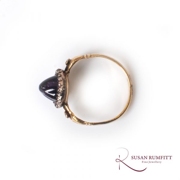 An antique amethyst sugar loaf and diamond fede ring