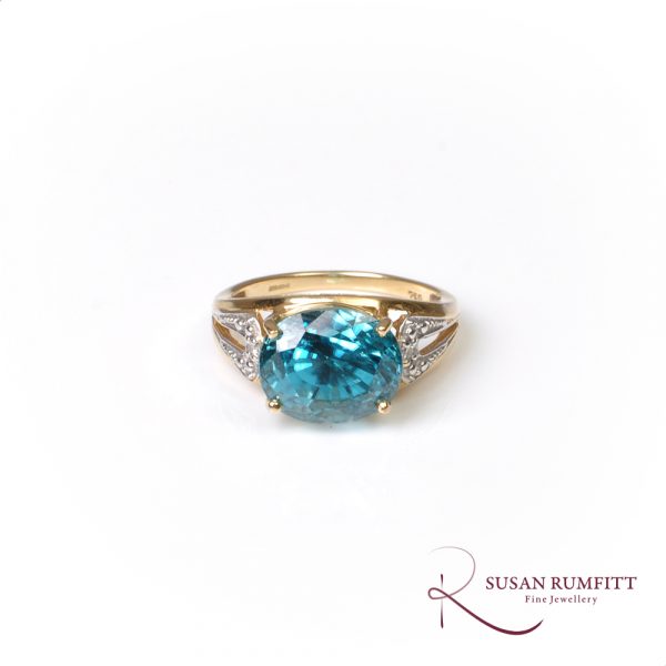 Blue zircon and diamond accent ring