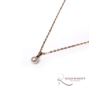 A Cultured Pearl and Diamond Drop Pendant Necklace