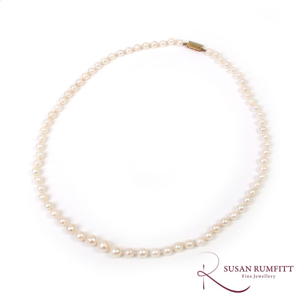 A Graduated Cultured Pearl Necklace with Emerald Clasp