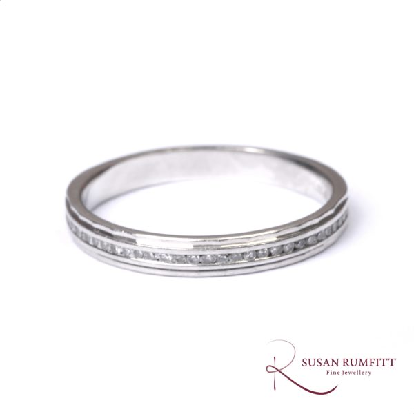A Diamond Half Eternity Ring with Faceted Border