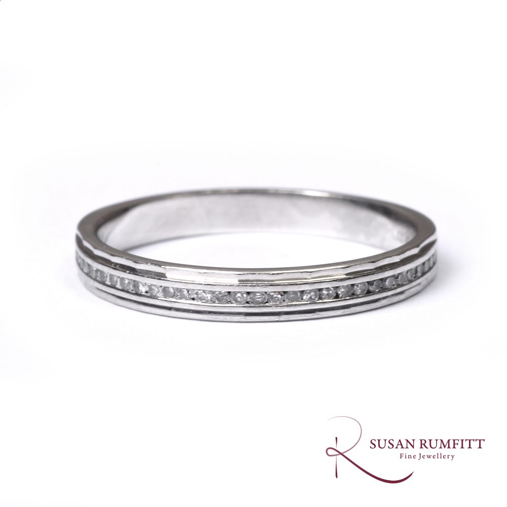 A Diamond Half Eternity Ring with Faceted Border