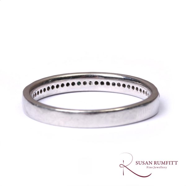 A Diamond Half Eternity Ring with Faceted Border