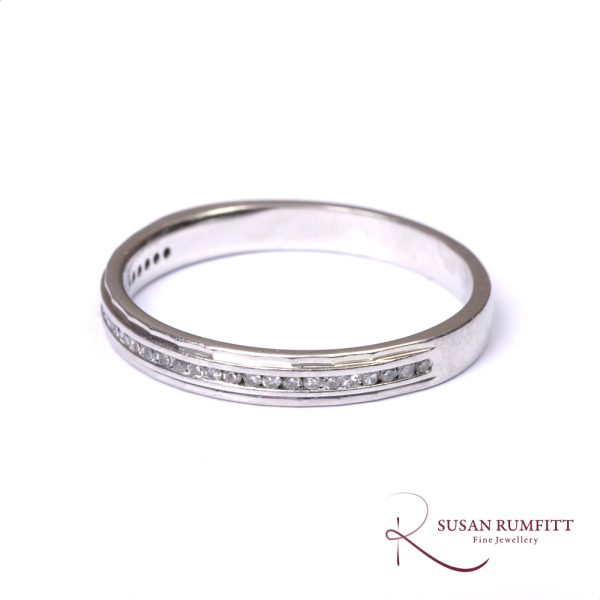A Diamond Half Eternity Ring with Faceted Border