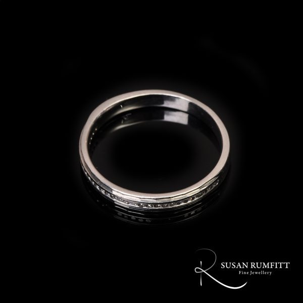 A Diamond Half Eternity Ring with Faceted Border