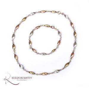 A Three Colour Gold Necklace and Bracelet Set