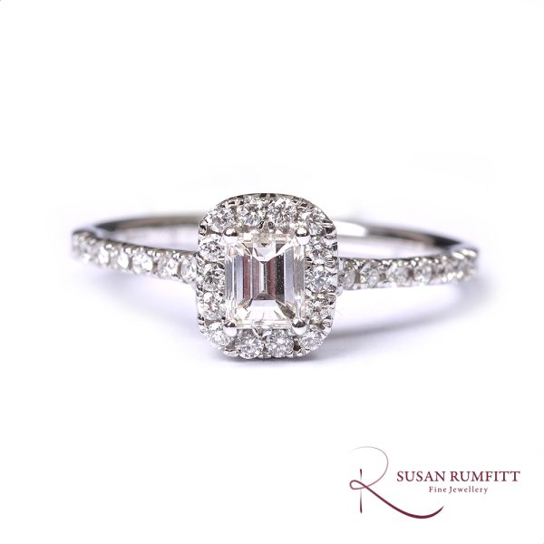 An Emerald Cut Diamond Cluster Ring