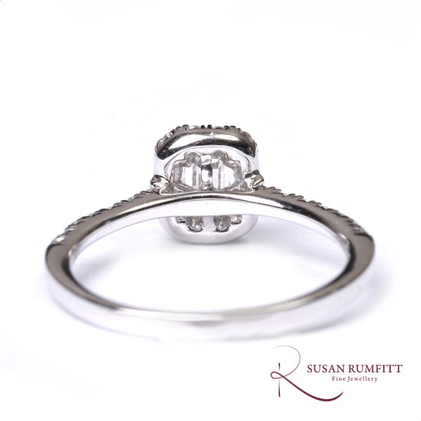 An Emerald Cut Diamond Cluster Ring